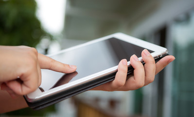 Hand hold white tablet