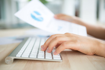 Closeup of business woman hand typing on keyboard