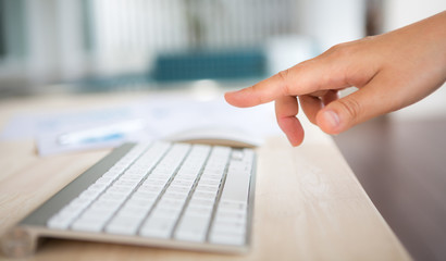 Closeup of business woman hand typing on keyboard