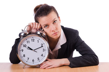 Businesswoman with clock missing her deadlines