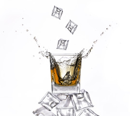 Whisky with ice cubes splash