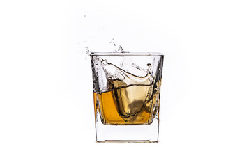 Whisky with ice cubes splash