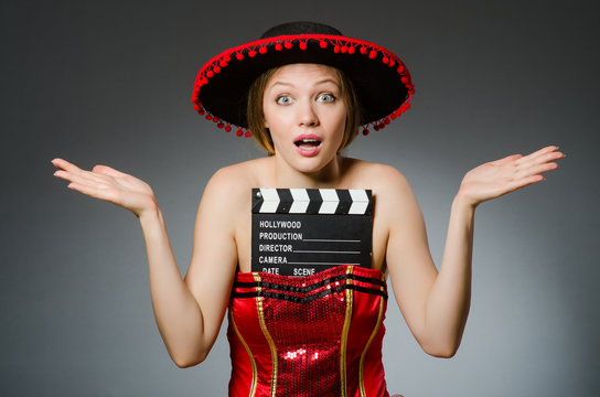 Funny mexican woman with sombrero and movie clapboard