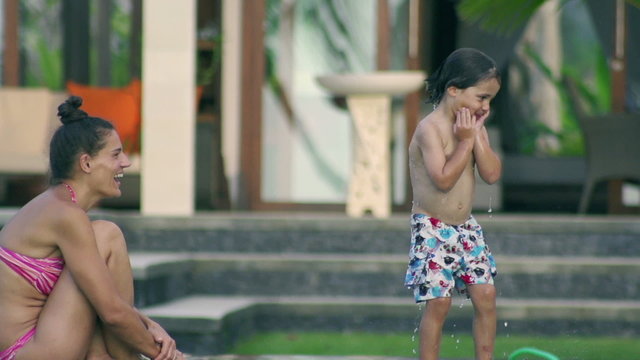 Mother and son having fun in the pool, slow motion 240fps