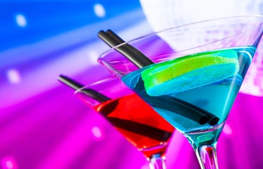 red and blue cocktail with sparkling disco ball background