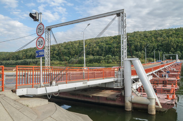 Pontoon bridge across the river in the summer