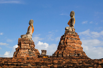old buddha statue and brick