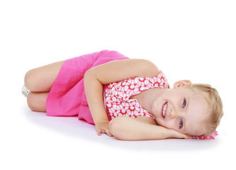 Obraz premium Cute little girl smiling lying on the floor