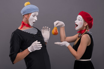 Portrait of funny mime couple with white faces and emotions isol