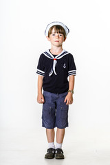 Cute little boy dressed in sailor suit