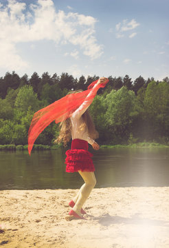 Vintage portrait of cutly girl dance with red Scarf at the river