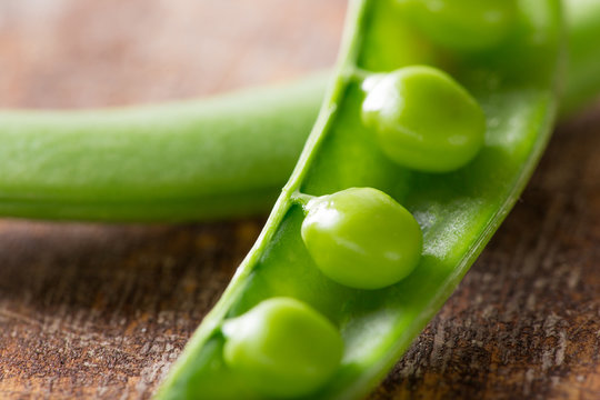 Fresh peas on wooden table