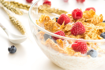 Cereal flakes with fresh raspberry closeup