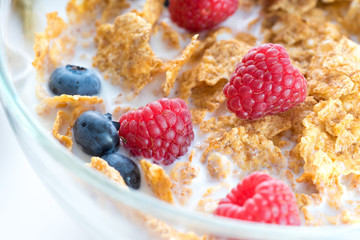 Cereal flakes with fresh raspberry closeup