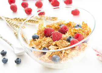 Cereal flakes with fresh raspberry closeup