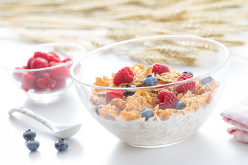 Cereal flakes with fresh raspberry closeup