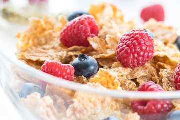 Cereal flakes with fresh raspberry closeup