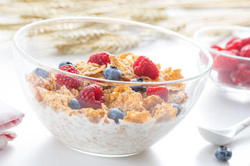 Cereal flakes with fresh raspberry closeup