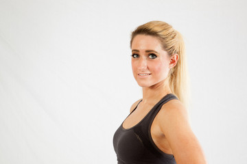 Blond woman in exercise outfit, looking at the camera