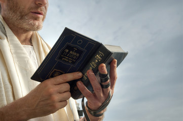Jewish man engaged in morning prayers.