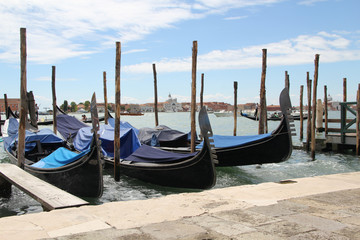 Obraz na płótnie Canvas Venetian landscape with gondolas and mooring piles.
