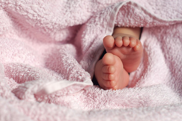 Baby feet under blanket