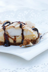 A piece of meringue cake on white background