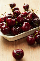 Fresh cherries in bowl on table