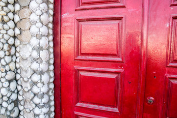 shells wall and red door