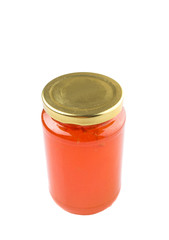 Orange fruit jam in a bottle over white background