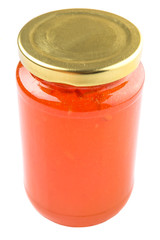 Orange fruit jam in a bottle over white background