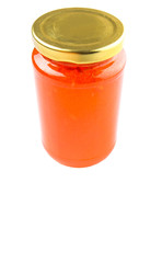 Orange fruit jam in a bottle over white background