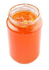 Orange fruit jam in a bottle over white background