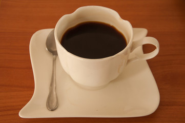 black coffee with white ceramic cup and spoon