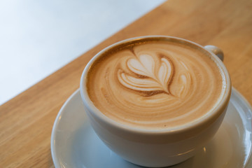 A Latte Coffee art on the wooden desk