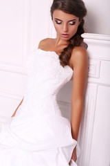 Fototapeta na wymiar beautiful young bride with dark hair in elegant dress