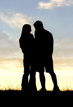 Loving Couple Silhouette Holding Hands at Sunset
