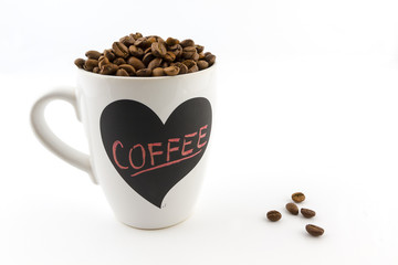 Roasted coffee beans in a cup with heart