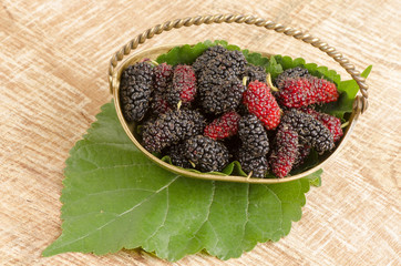 Mulberry on old wood background.