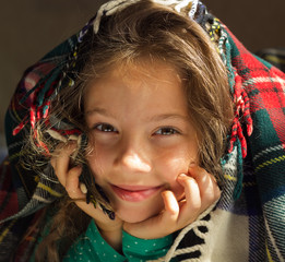 closeup Portrait of cute smiling girl look out from plaid