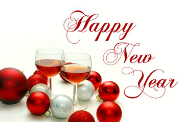 Two Wine Glasses Surrounded by Christmas Decorations with Happy
