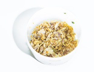 Braised leeks in cup on white background