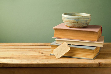 Vintage books and bowl on wooden table