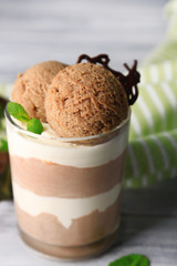 Tasty chocolate mousse with sorbet on wooden table