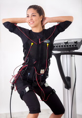 woman exercise trunk-bending forward  on  electro stimulation ma
