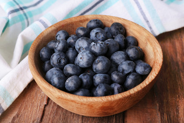 Wooden bowl of blueberries
