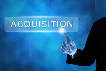 business hand pushing acquisition button