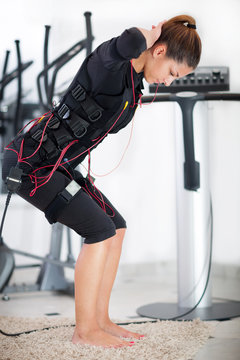 young woman exercise on electro stimulation machine