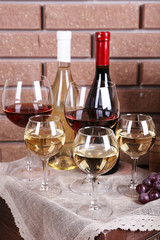 Bottles and glasses of wine and ripe grapes