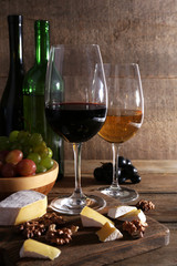 beautiful still life with wine, cheese and ripe grape